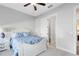 Cozy bedroom featuring a white bed frame and blue floral bedding, complemented by a ceiling fan at 13059 Stoddart Ave, Orlando, FL 32827