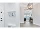 Convenient entryway with coat hooks, a bench, and view to the office at 13059 Stoddart Ave, Orlando, FL 32827