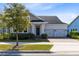 Charming single-Gathering home showcasing a well-manicured lawn, brick-paved driveway, and inviting two-car garage at 13059 Stoddart Ave, Orlando, FL 32827