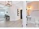 Hallway view to the office and powder room with pedestal sink and patterned tile floor at 13059 Stoddart Ave, Orlando, FL 32827