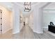 Bright hallway featuring modern lighting, neutral paint, and sleek flooring at 13059 Stoddart Ave, Orlando, FL 32827