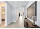 Elegant hallway with gray wood floors, leading to the living area and bedroom at 13059 Stoddart Ave, Orlando, FL 32827
