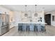Modern kitchen with stainless steel appliances, gray island, and white cabinets at 13059 Stoddart Ave, Orlando, FL 32827