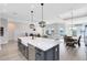 Open concept living space with kitchen island, dining area, and water views at 13059 Stoddart Ave, Orlando, FL 32827