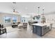 Open floor plan with kitchen, dining and living areas, and water views at 13059 Stoddart Ave, Orlando, FL 32827
