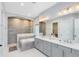 Elegant main bathroom with double vanity, soaking tub, and walk-in shower for a spa-like experience at 13059 Stoddart Ave, Orlando, FL 32827