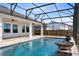 Outdoor pool area in a screened enclosure with water fountains, seamlessly blending indoor and outdoor living at 13059 Stoddart Ave, Orlando, FL 32827