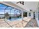 Inviting covered patio and pool with lake view, perfect for outdoor entertaining at 13059 Stoddart Ave, Orlando, FL 32827