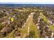 Expansive aerial view showcasing the property's location adjacent to a lush golf course at 1322 Ensenada Dr, Orlando, FL 32825