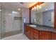 Modern bathroom featuring a glass-enclosed shower, granite countertop, and a framed mirror at 1322 Ensenada Dr, Orlando, FL 32825