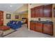 A cozy room featuring a wet bar with cabinets, a comfortable couch, and a bed at 1322 Ensenada Dr, Orlando, FL 32825