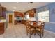 Eat-in kitchen with wooden cabinetry, stainless appliances, tile floor and a separate desk area at 1322 Ensenada Dr, Orlando, FL 32825
