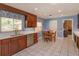Eat-in kitchen with wooden cabinetry, stainless appliances, tile floor and a view of the backyard at 1322 Ensenada Dr, Orlando, FL 32825