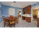 Eat-in kitchen with wooden cabinetry, stainless appliances, tile floors and a separate desk area at 1322 Ensenada Dr, Orlando, FL 32825
