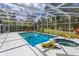 Screened in pool and spa, surrounded by lush greenery and open space at 1322 Ensenada Dr, Orlando, FL 32825