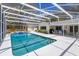 Screened pool with in-ground spa, outdoor furniture, and manicured landscaping at 1322 Ensenada Dr, Orlando, FL 32825