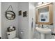 Charming powder room featuring rustic wood-framed mirror and tasteful decor at 1325 Seburn Rd, Apopka, FL 32703