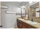 Well-lit bathroom with double sinks, rustic wood-framed mirrors, and neutral décor at 1325 Seburn Rd, Apopka, FL 32703