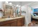 Double sink bathroom with neutral colors, rustic wood mirrors, and access to bedroom at 1325 Seburn Rd, Apopka, FL 32703