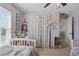 Charming bedroom featuring neutral walls, a polka-dot curtain, and ample natural light from a window at 1325 Seburn Rd, Apopka, FL 32703