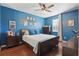 Comfortable primary bedroom features dark furniture, wood floors, and a large ceiling fan at 1325 Seburn Rd, Apopka, FL 32703