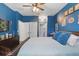 Bright primary bedroom with blue walls, a comfortable bed, and a view of the closet at 1325 Seburn Rd, Apopka, FL 32703