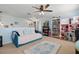 Comfortable bedroom with neutral walls, ceiling fan, and a plush daybed with decorative pillows and throw at 1325 Seburn Rd, Apopka, FL 32703