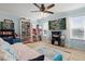 Spacious bedroom with neutral walls, two windows, a ceiling fan, and cozy daybed with stylish furnishings at 1325 Seburn Rd, Apopka, FL 32703