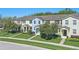 Charming townhouses featuring manicured lawns, mature trees, and colorful exterior paint schemes at 1325 Seburn Rd, Apopka, FL 32703