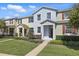 Attractive townhouse with well-maintained landscaping, sidewalk, and front entrance at 1325 Seburn Rd, Apopka, FL 32703