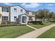 Inviting two-story townhouse featuring manicured lawn and sidewalk leading to the front door at 1325 Seburn Rd, Apopka, FL 32703