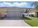 Two-car garage exterior with updated curb appeal, exterior lighting, and landscaping at 1325 Seburn Rd, Apopka, FL 32703