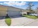 Two-car garage exterior with updated curb appeal, exterior lighting, and landscaping at 1325 Seburn Rd, Apopka, FL 32703