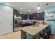 Well-lit kitchen features stainless steel appliances and a spacious granite countertop with bar seating at 1325 Seburn Rd, Apopka, FL 32703