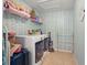 Well-organized laundry room with washer, dryer, and shelving for storage, creating a functional space at 1325 Seburn Rd, Apopka, FL 32703