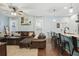 Open-concept living room features comfortable leather seating and bar-style kitchen counter at 1325 Seburn Rd, Apopka, FL 32703
