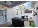 Private outdoor patio featuring brick pavers, string lights, barbecue, and privacy fencing at 1325 Seburn Rd, Apopka, FL 32703
