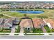 A beautiful aerial view shows the tile roofs and backyard lake views of this luxury home at 13346 Alderley Dr, Orlando, FL 32832