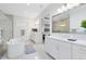 Bright bathroom featuring dual vanities, a soaking tub, and a glass-enclosed shower at 13346 Alderley Dr, Orlando, FL 32832