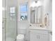Bright bathroom featuring white vanity, toilet and glass enclosed shower with window views and tile flooring at 13346 Alderley Dr, Orlando, FL 32832