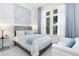 A bright bedroom features light blue decor and large windows at 13346 Alderley Dr, Orlando, FL 32832