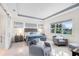 Serene bedroom with a comfortable bed, sitting area, and large windows with natural light at 13346 Alderley Dr, Orlando, FL 32832