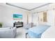 Bedroom featuring a TV, barn door to bathroom, sitting area and comfortable king bed at 13346 Alderley Dr, Orlando, FL 32832