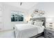 Comfortable bedroom showcasing a queen size bed, neutral decor, modern hexagon wall art, and a large window at 13346 Alderley Dr, Orlando, FL 32832