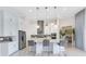 Modern kitchen features a large island with bar seating, stainless appliances, and white cabinetry at 13346 Alderley Dr, Orlando, FL 32832