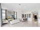 Spacious living room features modern furnishings, neutral decor, and seamless flow into the kitchen area at 13346 Alderley Dr, Orlando, FL 32832