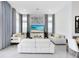 Bright living room featuring modern white sofas, a large TV, and elegant decor at 13346 Alderley Dr, Orlando, FL 32832