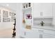 Bright mudroom with built-in storage, shelving and bench seating featuring white shaker cabinets and neutral decor at 13346 Alderley Dr, Orlando, FL 32832