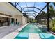 A stunning screened-in pool and patio featuring water features and outdoor seating with open views at 13346 Alderley Dr, Orlando, FL 32832