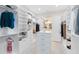 Bright walk-in closet with custom shelving and ample storage space, opens to bathroom at 13346 Alderley Dr, Orlando, FL 32832